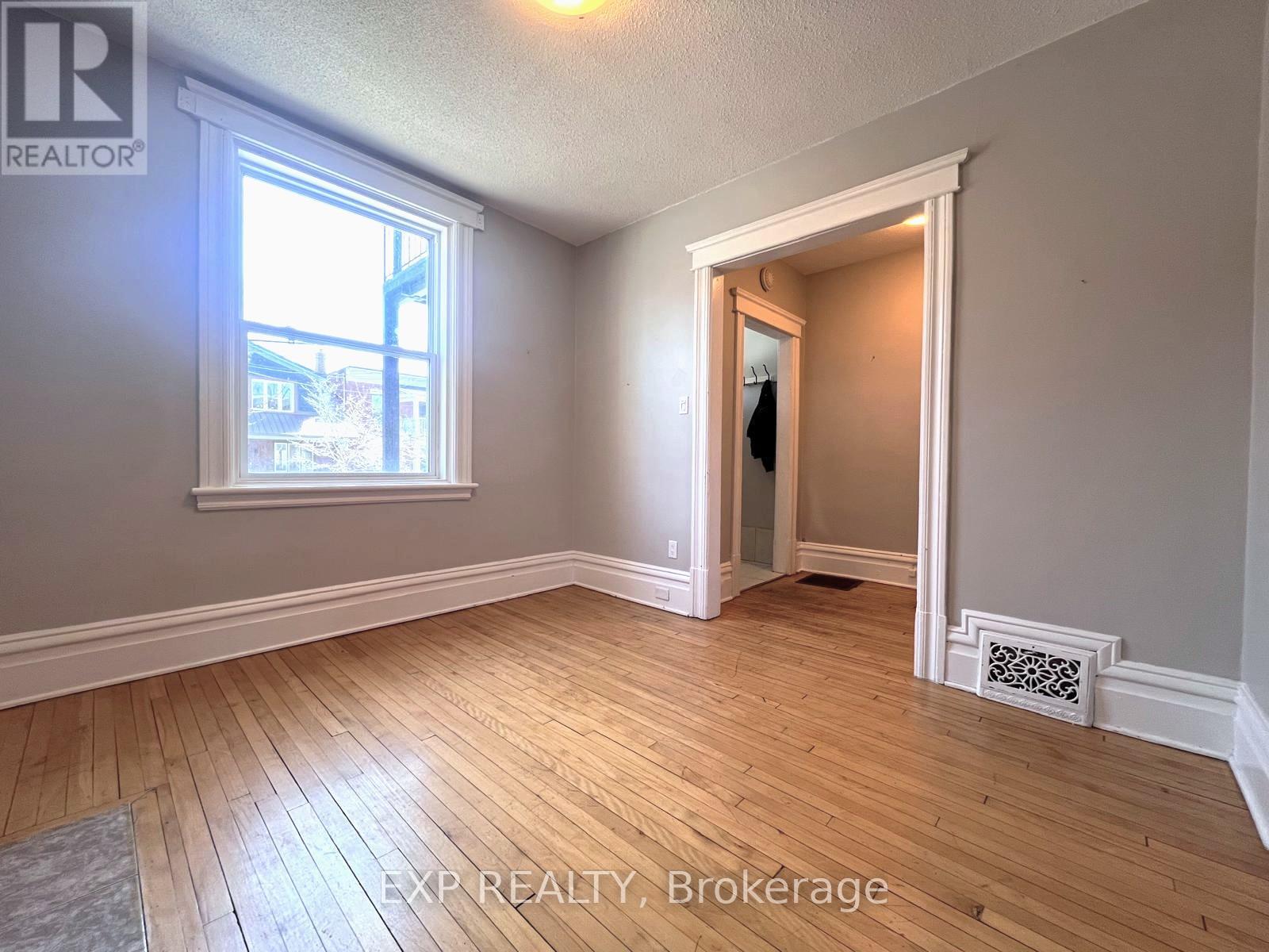 Living room with hardwood floors and large window