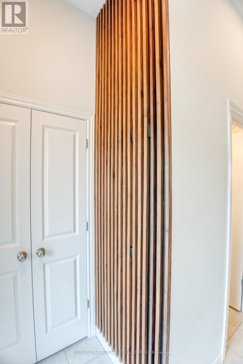 Feature wall in foyer with hidden hooks for coats
