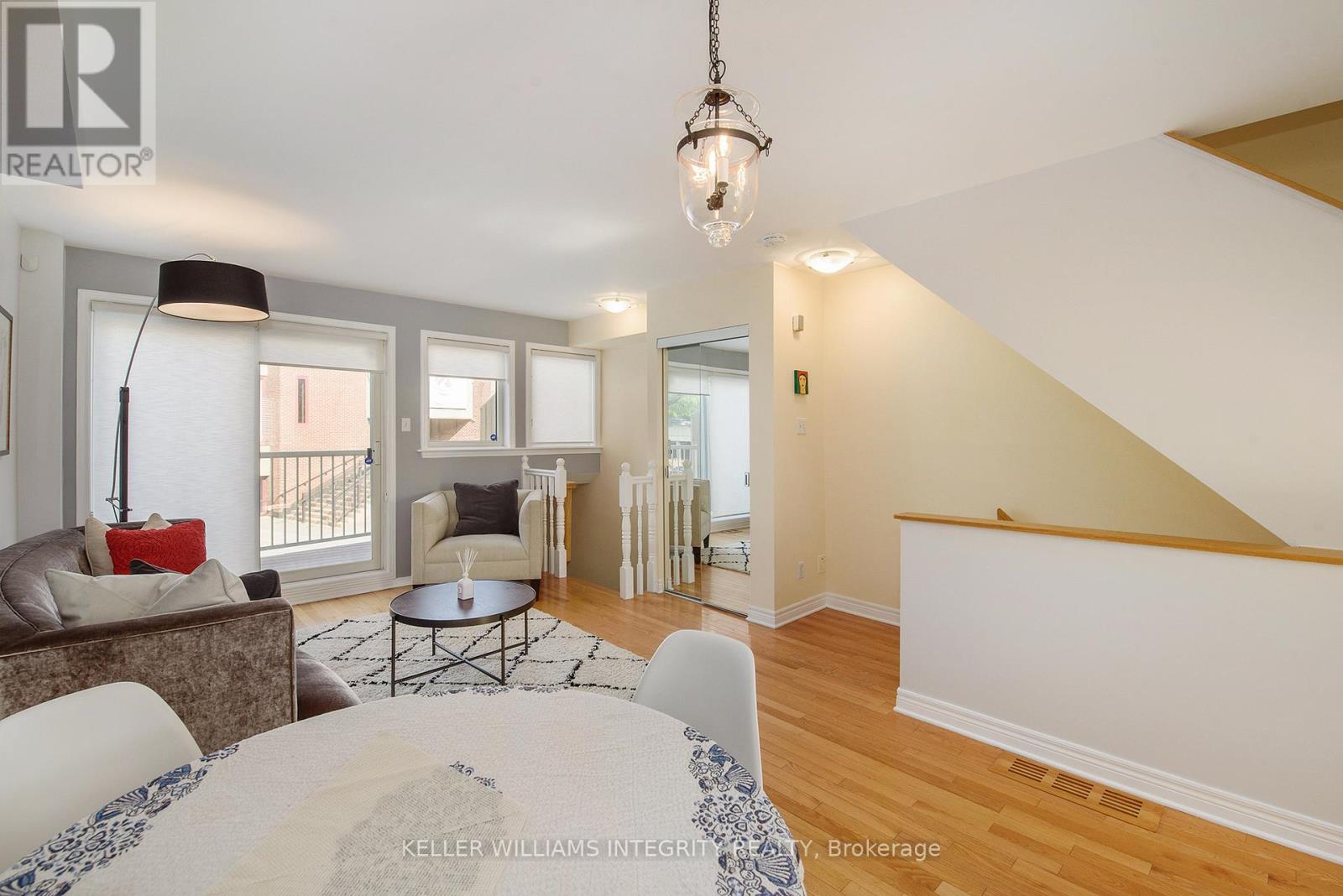 Oak hardwood stairs lead to spacious living area