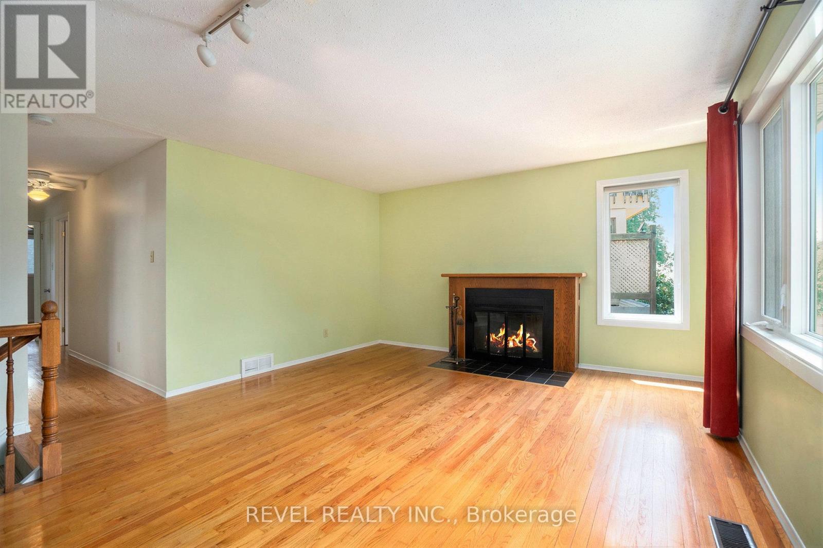 Note the oak floors and wood burning fireplace