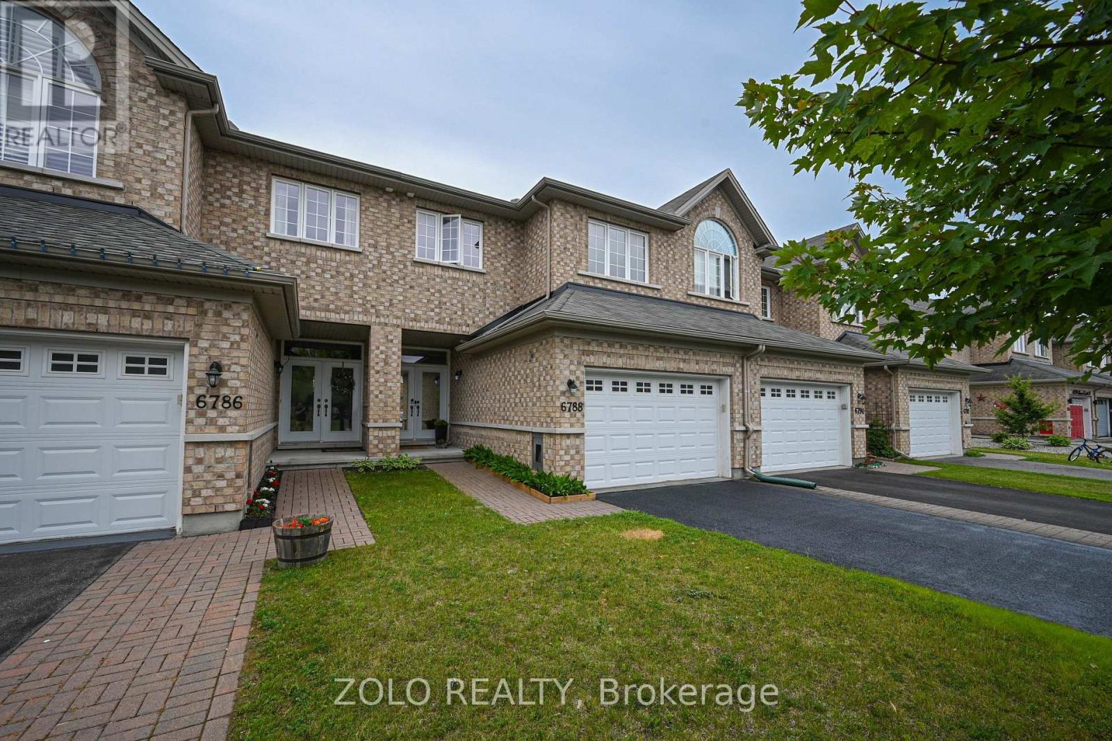 Interlock brick driveway to front step of home.