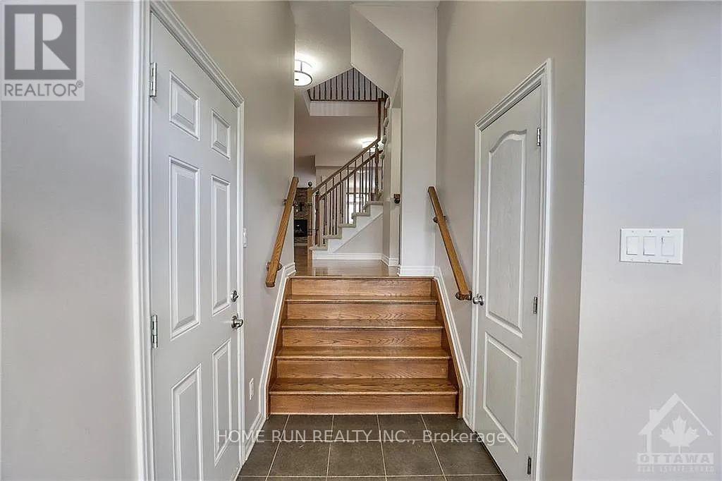 Foyer with tiled floor and dual stairway access