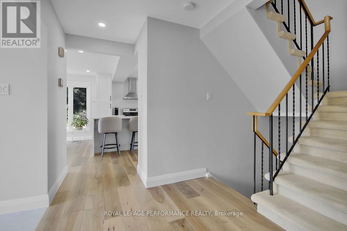 View of kitchen with stairs up and down.