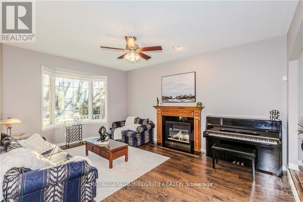 Main floor living room with fireplace and bay wind