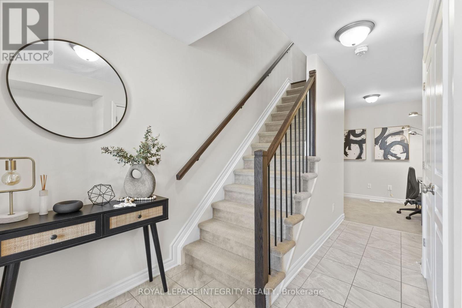 Welcoming foyer leads to den, garage & basement