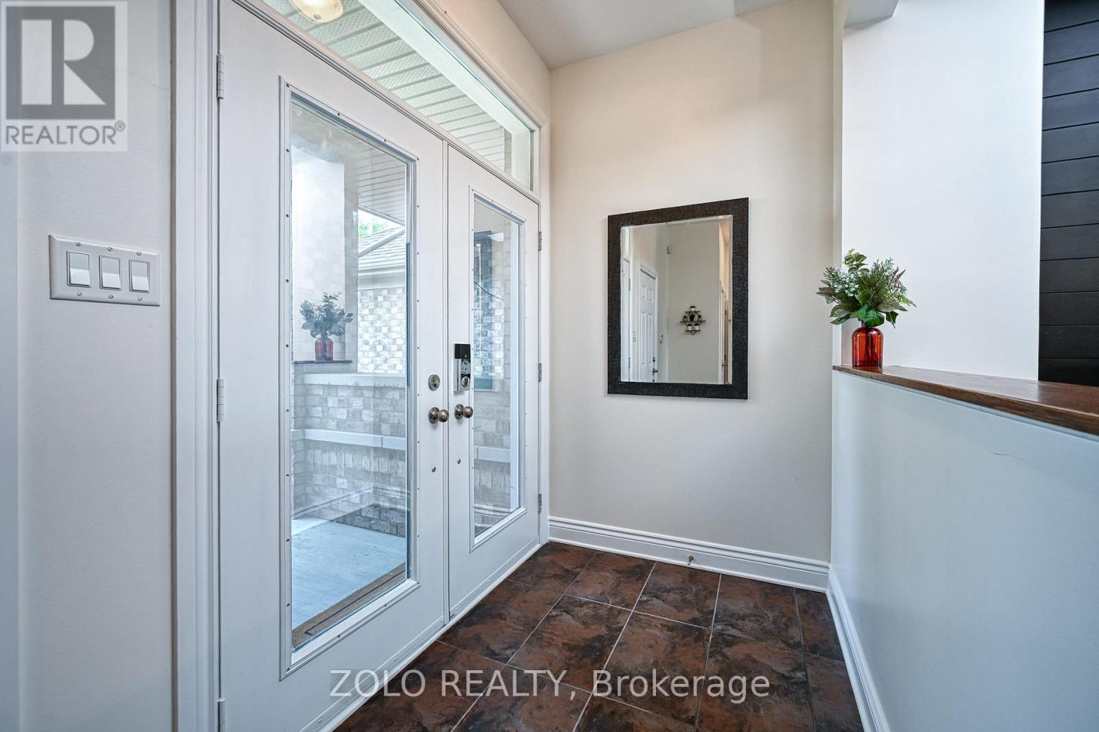 Large bright foyer with ceramic tile.