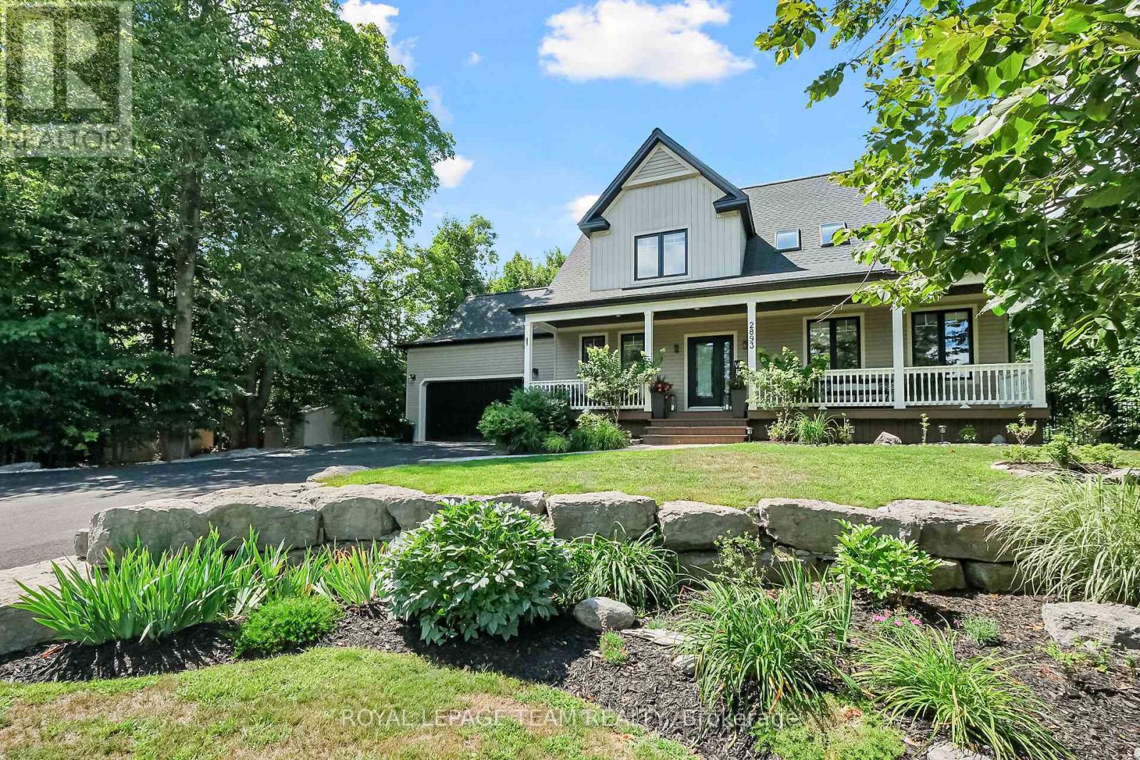 Beautifully lndscpd w/armour stone retaining wall
