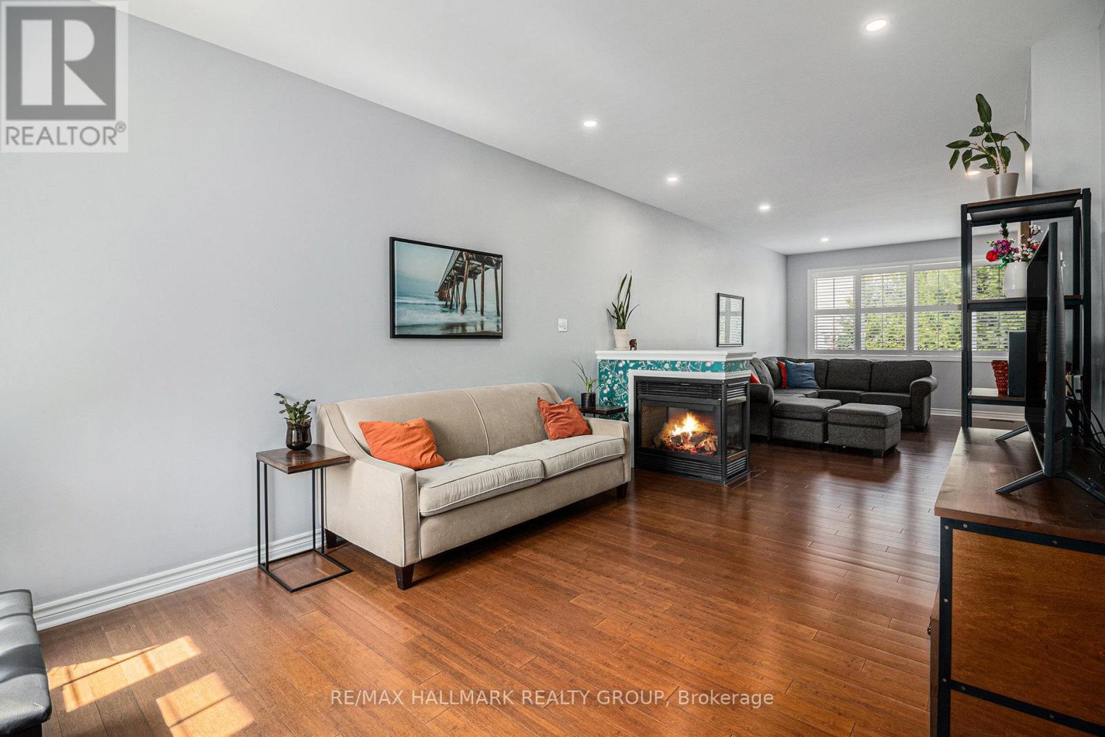 Hardwood flr in living room & 3 sided gas fire pl