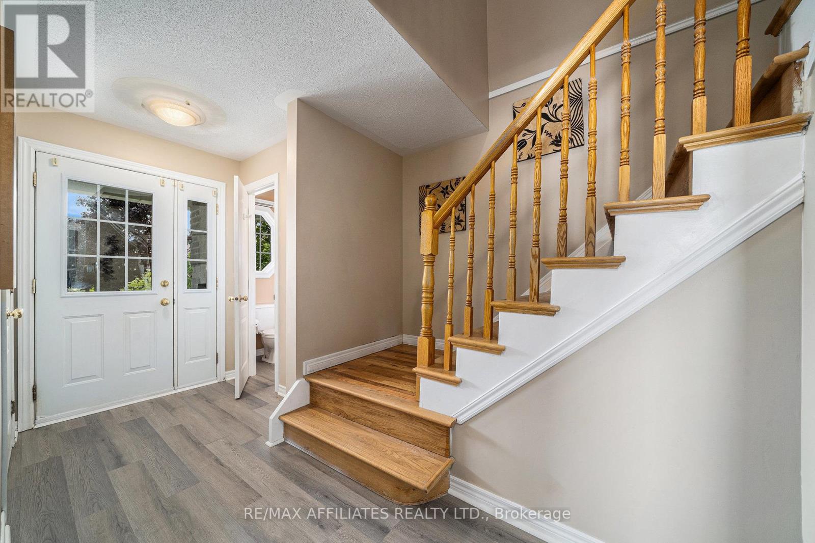 Bright entry with wood staircase