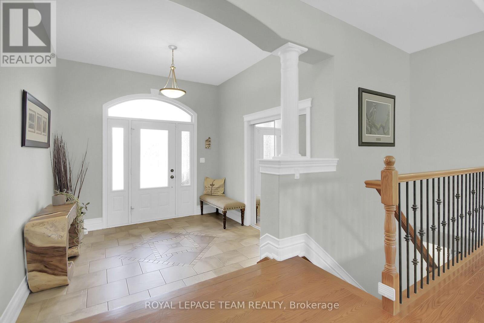 Expansive foyer with custom inlay design in tile.
