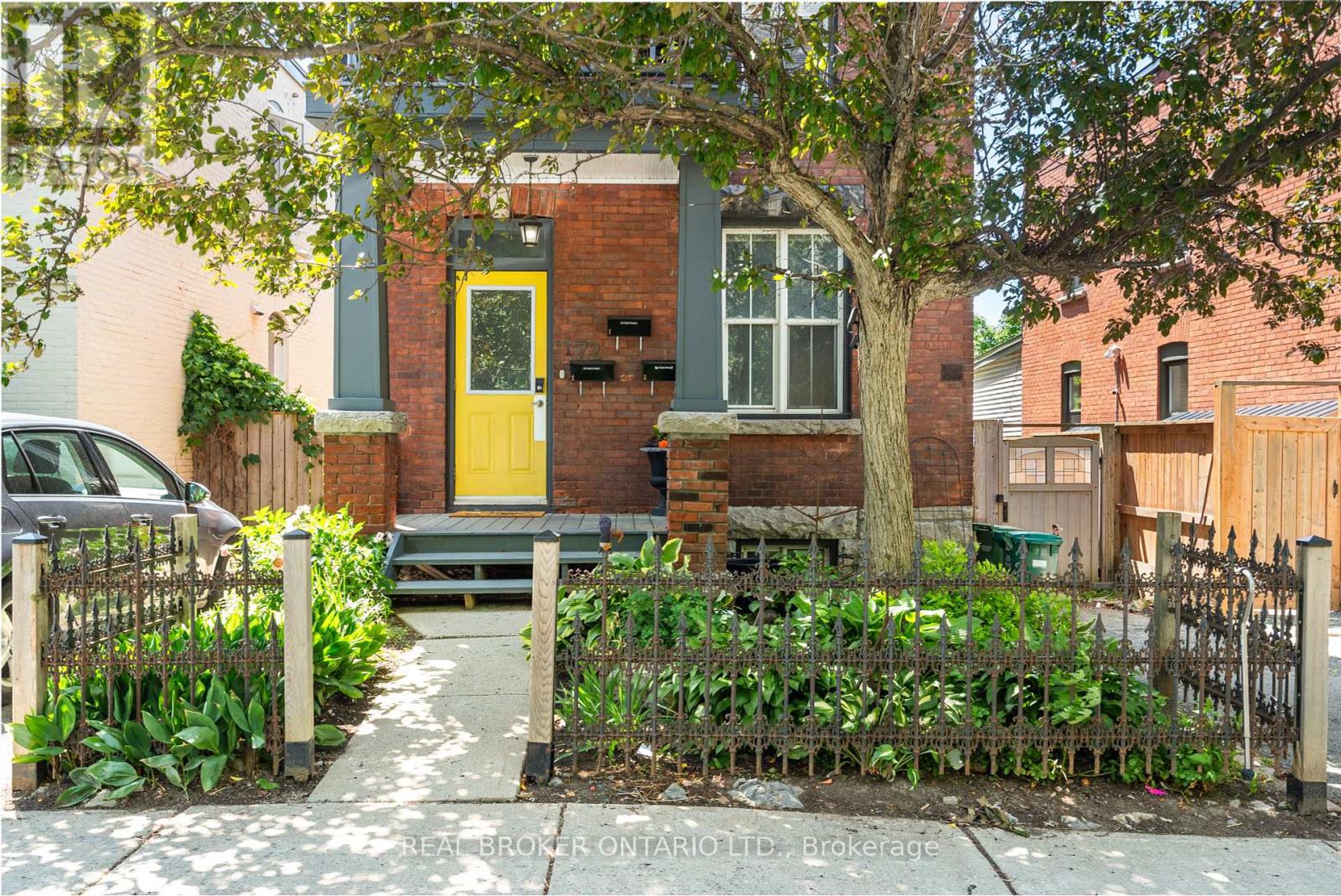 Landscaped front yard with parking to the left