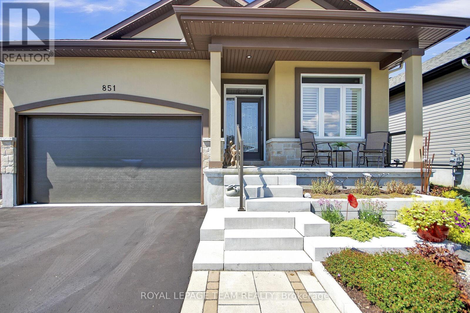 Interlock walkway, steps and gardens, front porch.