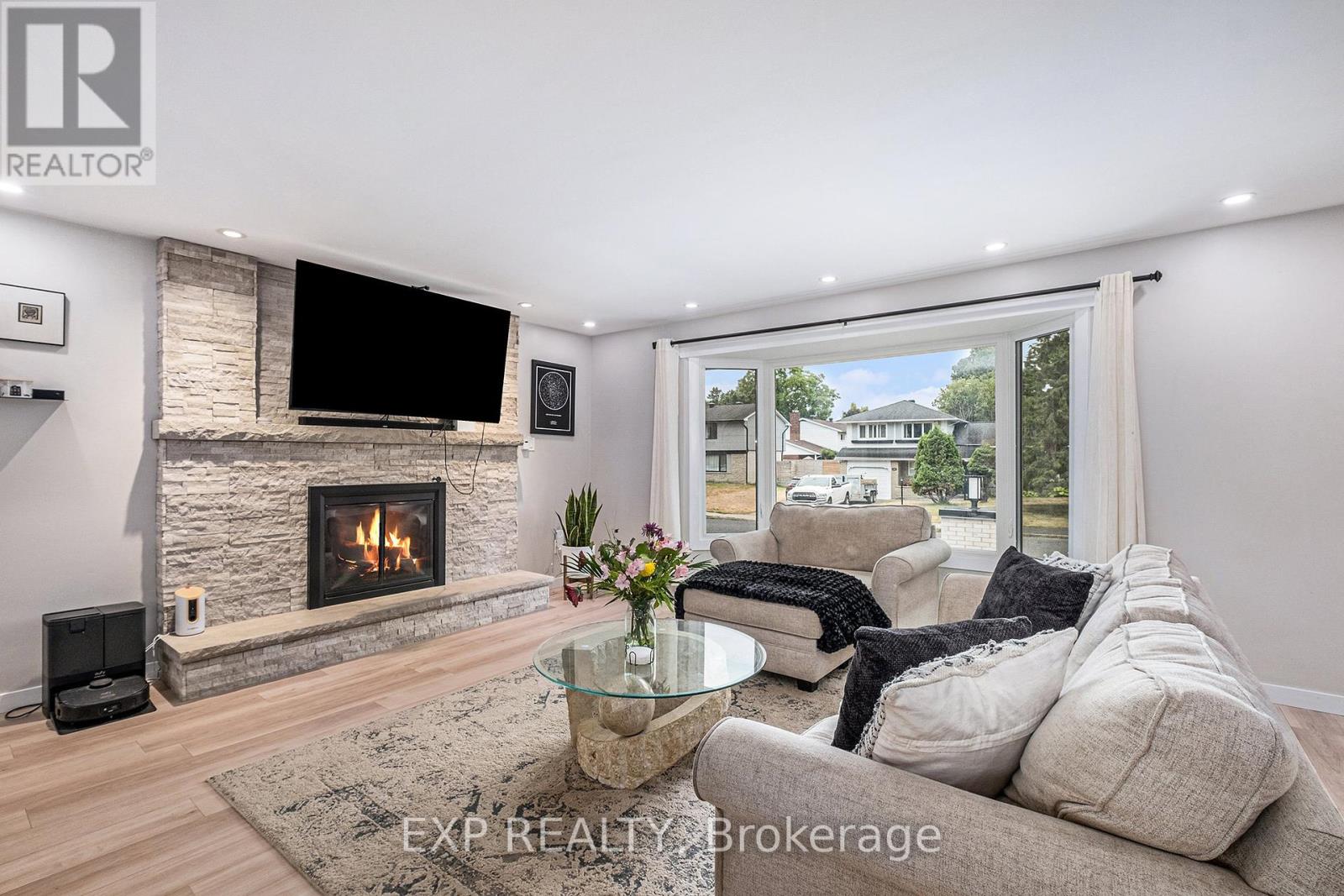 Cozy almond stone fireplace. Modern open layout
