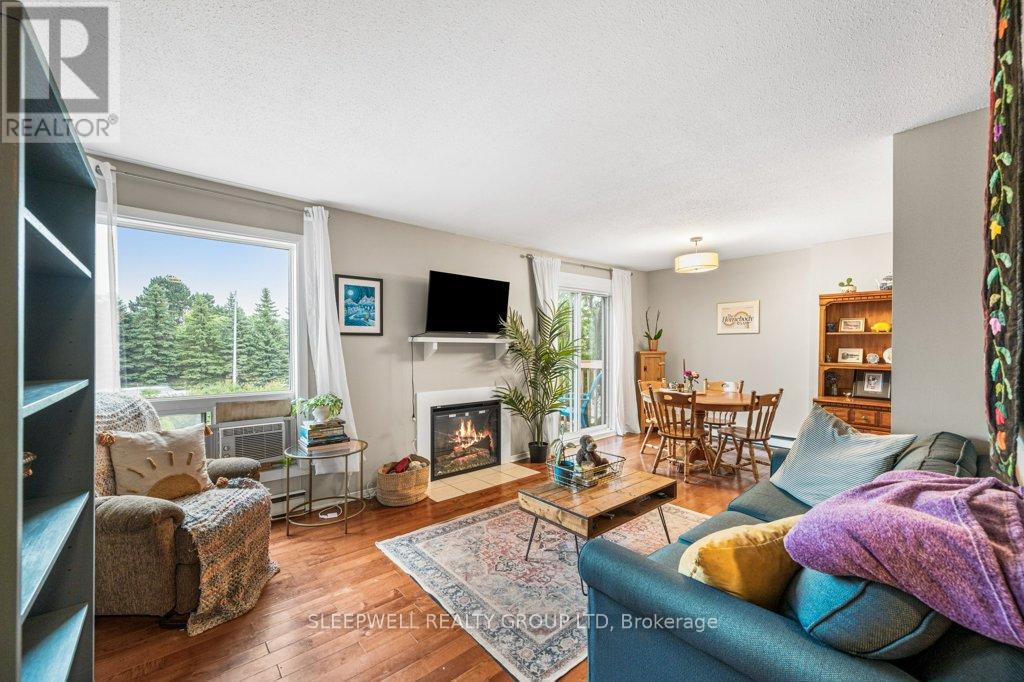 Bright living/dining area with electric fireplace