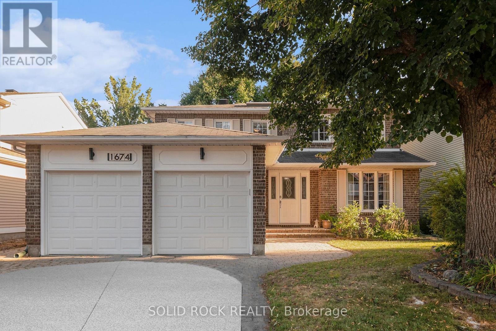Front of the house with attached 2-car garage.