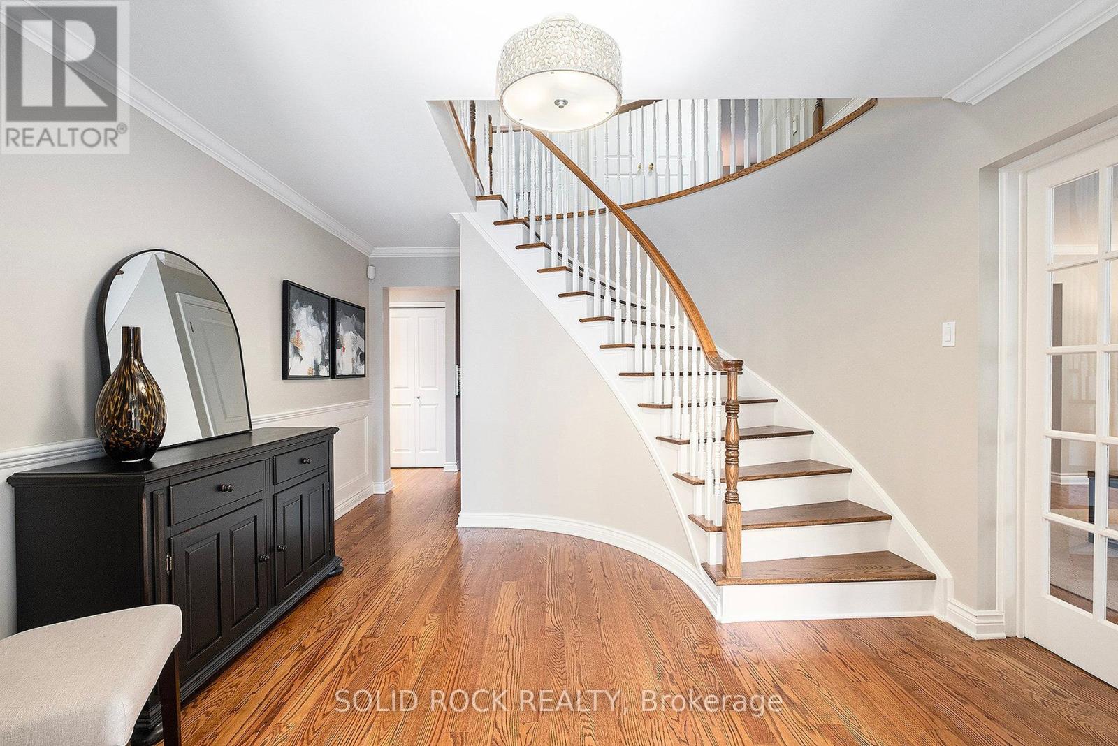 Sweeping stairs beyond the Foyer