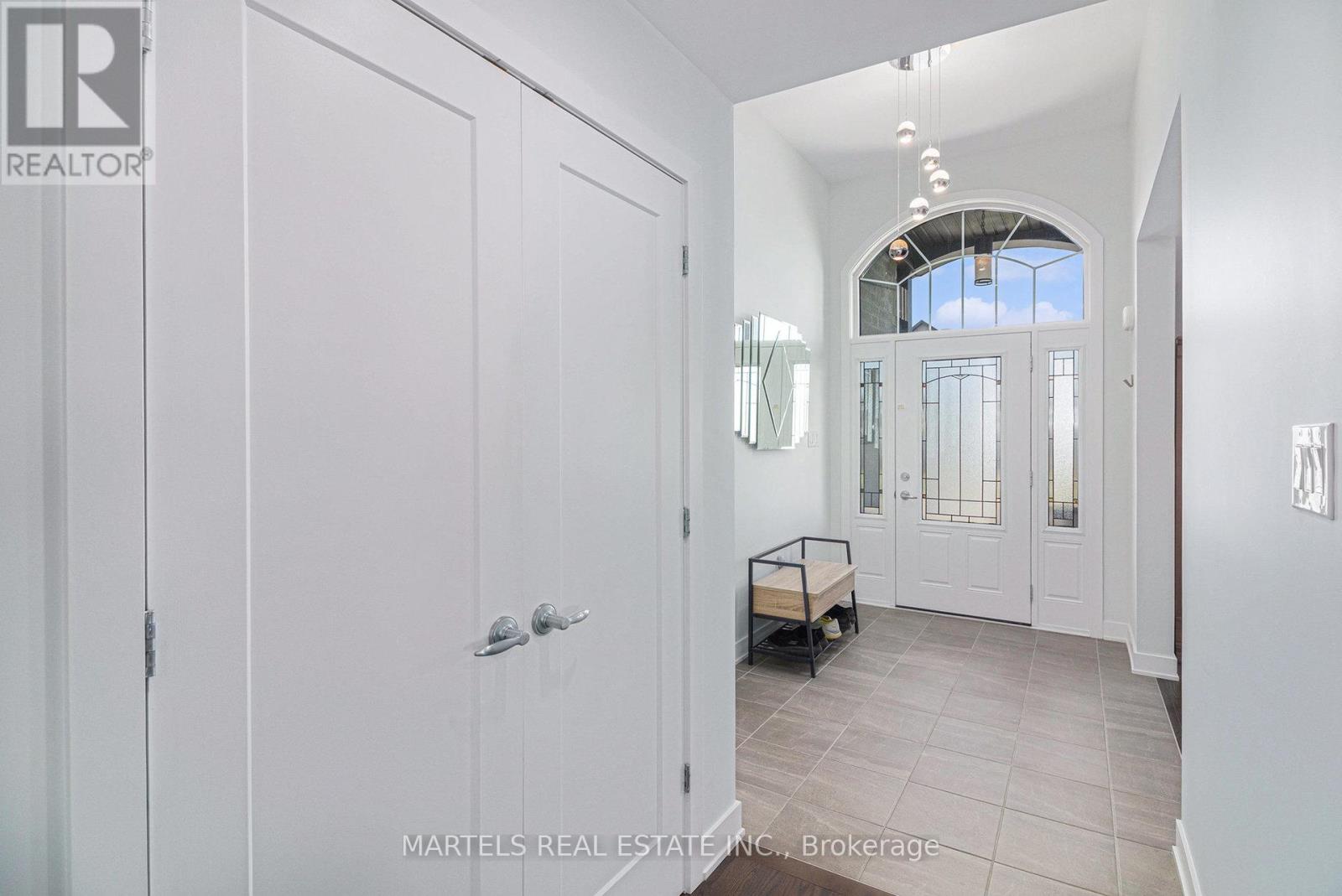 Greeted by a sunfilled foyer with soaring ceilings
