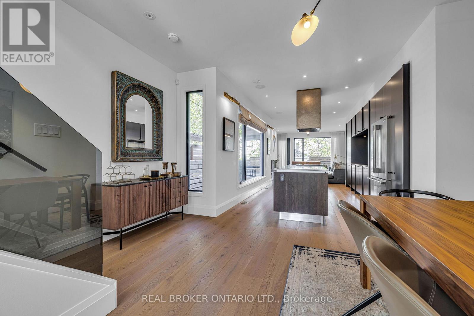 Open-concept main level with sweeping hardwoods
