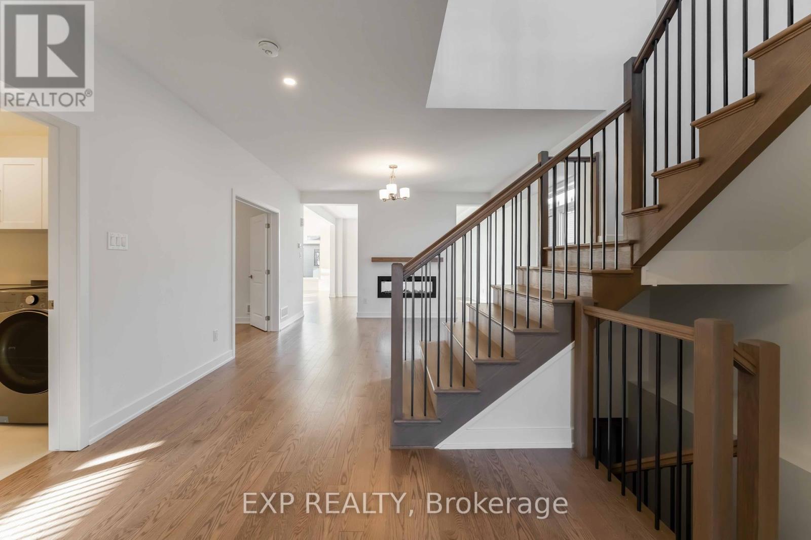 Lower hall, with hardwood staircase to second floo