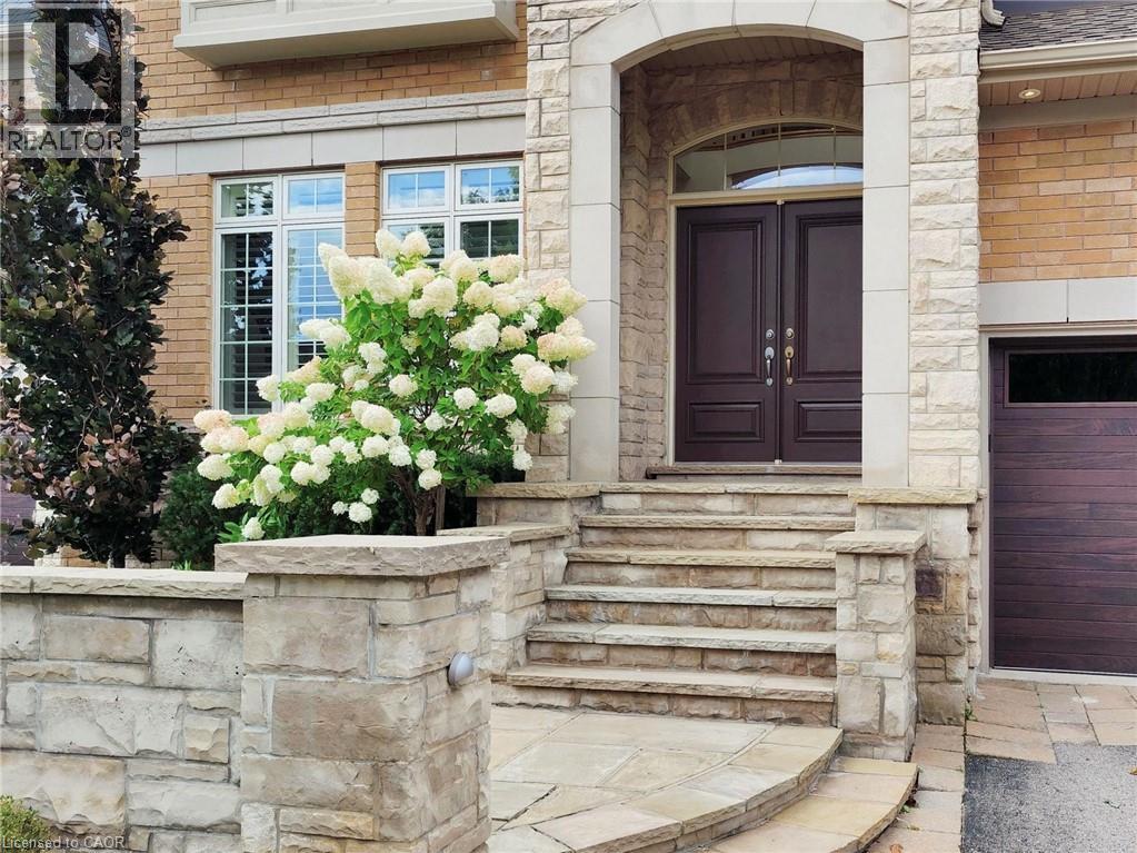Entrance to property with stone siding and brick siding