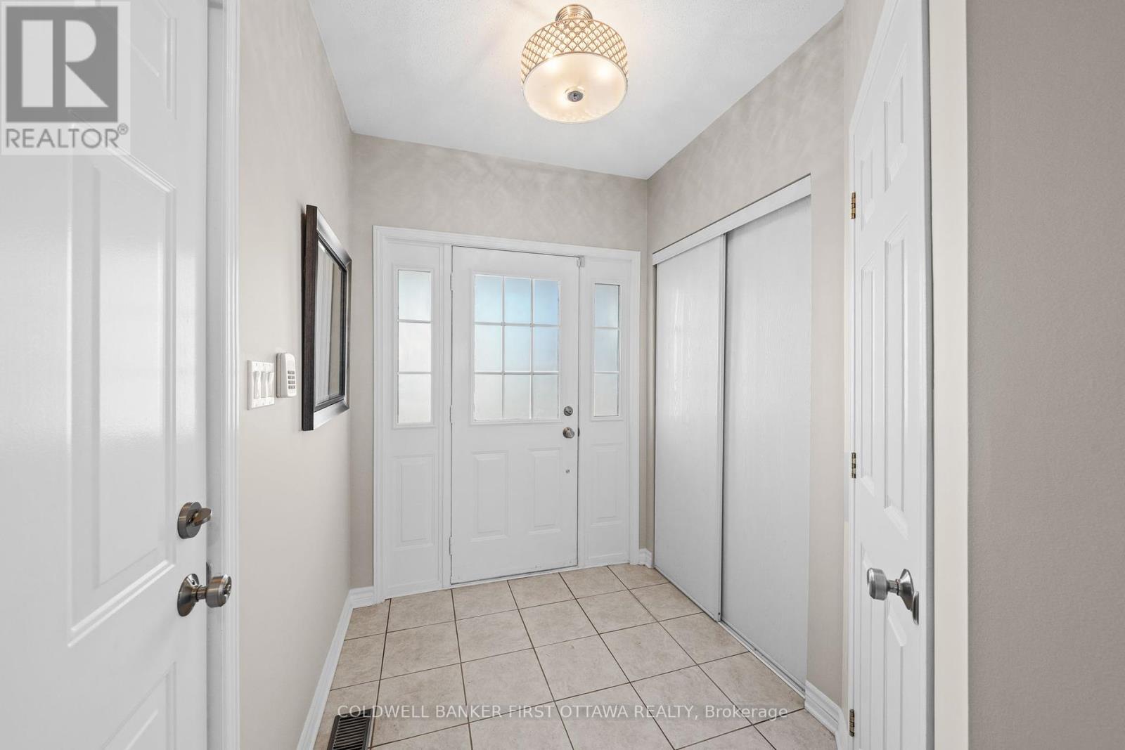 Welcoming, tiled front foyer w closet space.