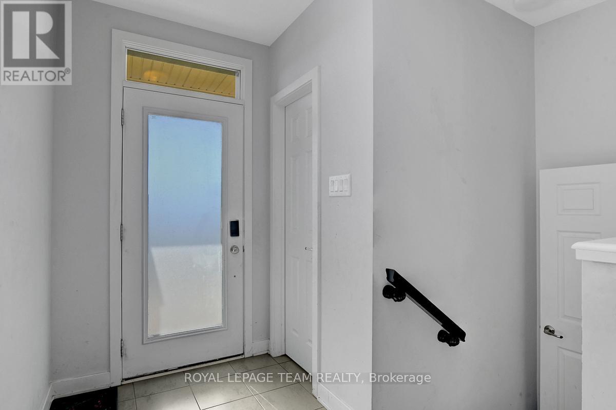 Bright tiled foyer with walk-in closet