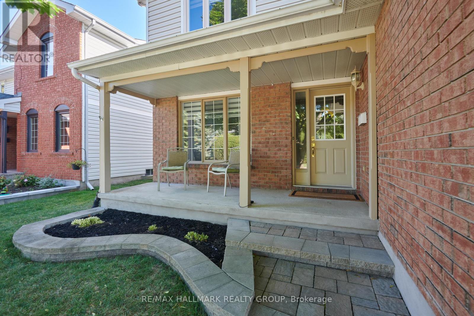 FRONT | covered porch, interlock pathway & garden