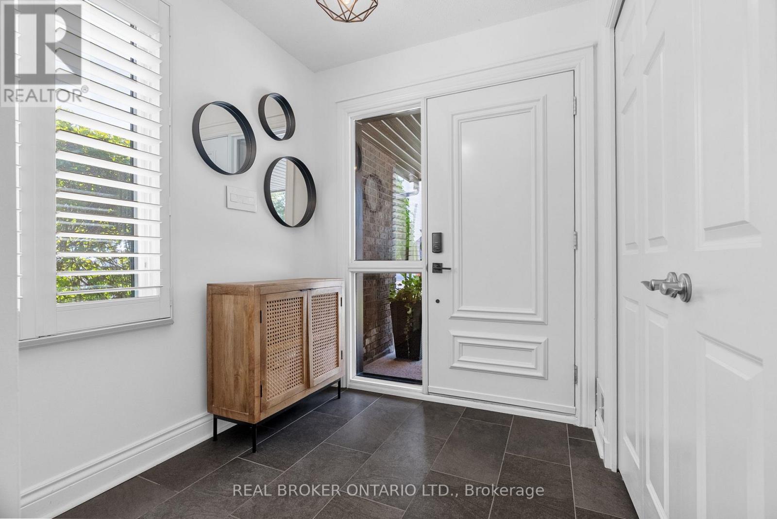 Foyer with large entryway closet and tiled floors