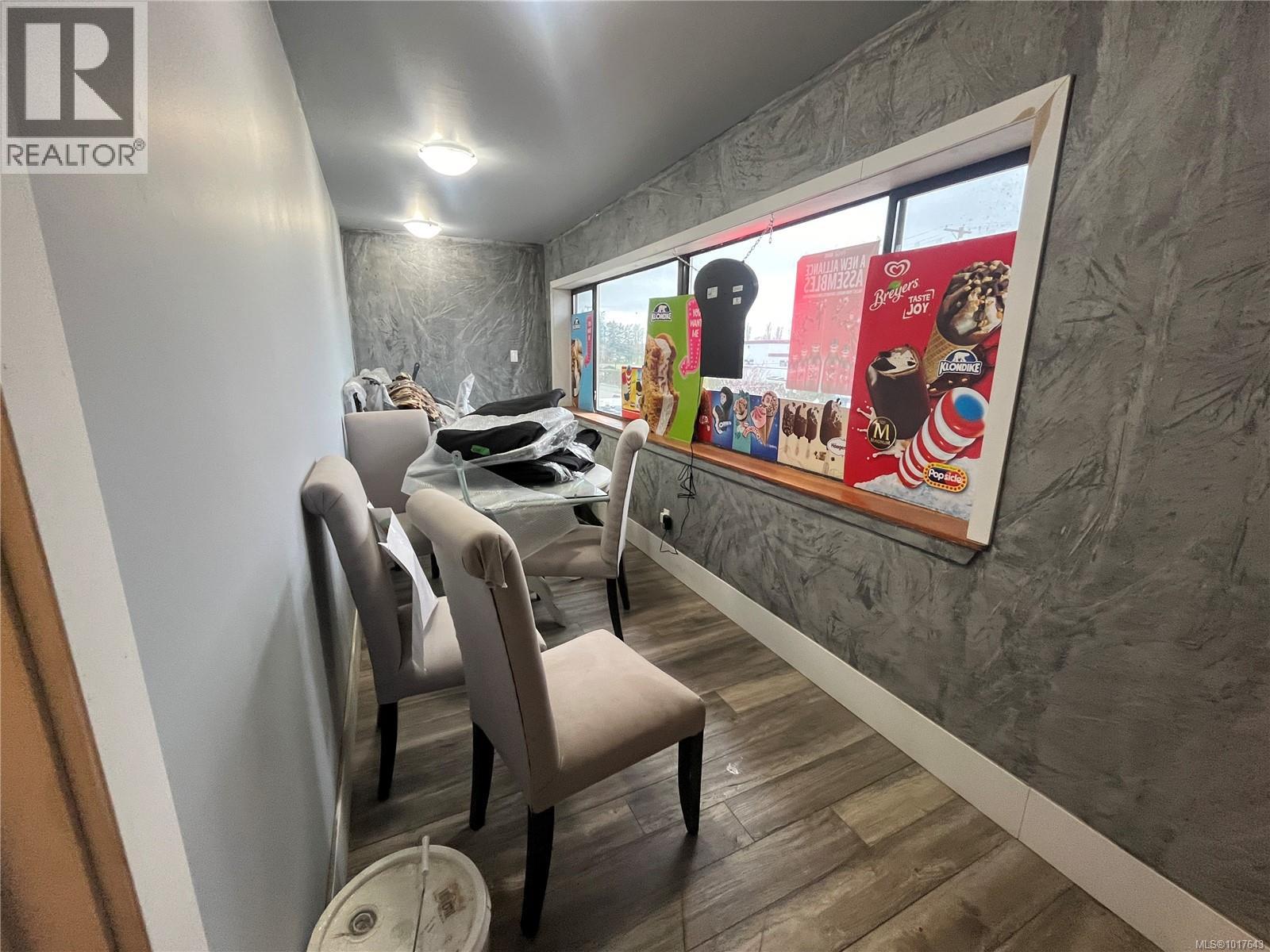 Cinema room featuring baseboards and wood finished floors