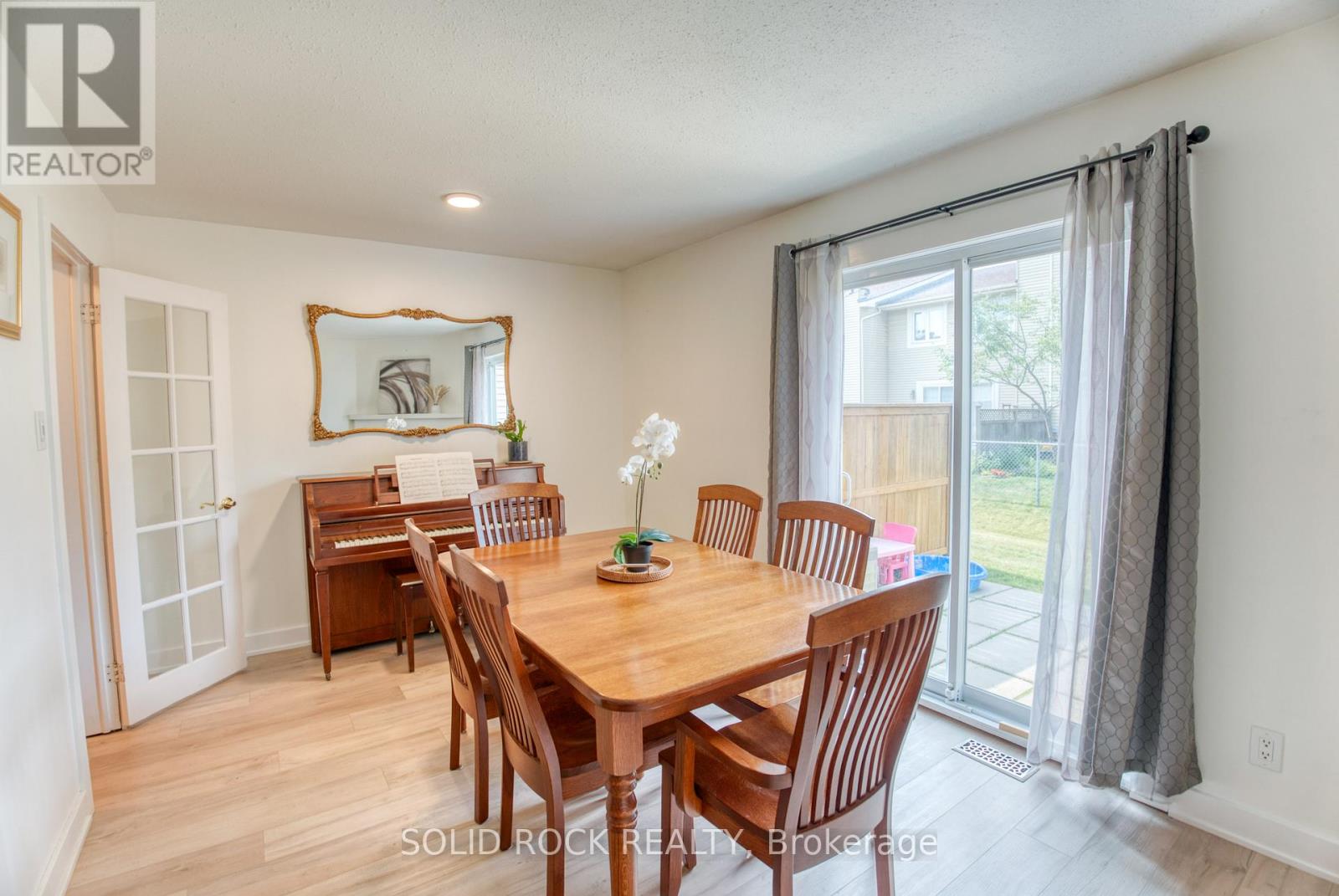 Dining room w/ pot lights & rear yard patio door.