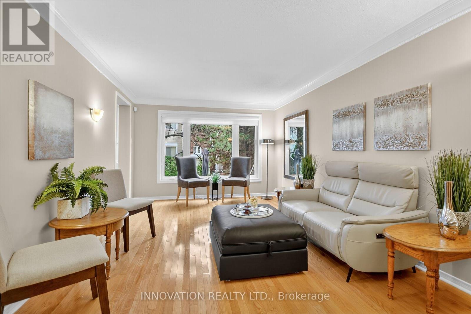 Bright & open living room with gleaming hardwood.