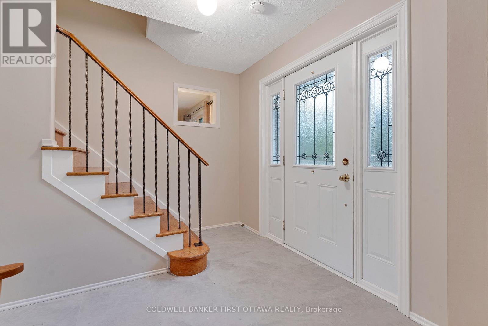 Welcoming foyer with new laminate tile flooring