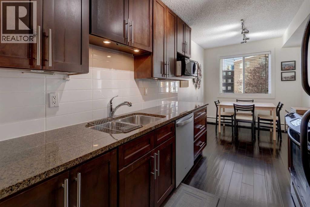 The cupboards are a MAPLE shaker hardwood with dark stain and lacquer finish.  The counters are slab style GRANITE with an eased edge profile