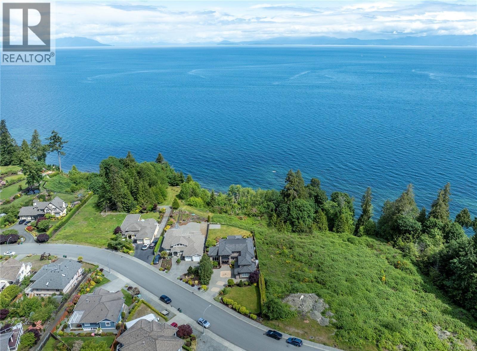 Aerial overview of property's location with a nearby body of water and nearby suburban area