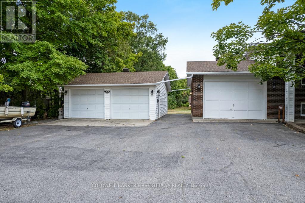 Summer view of single & detached double garage.