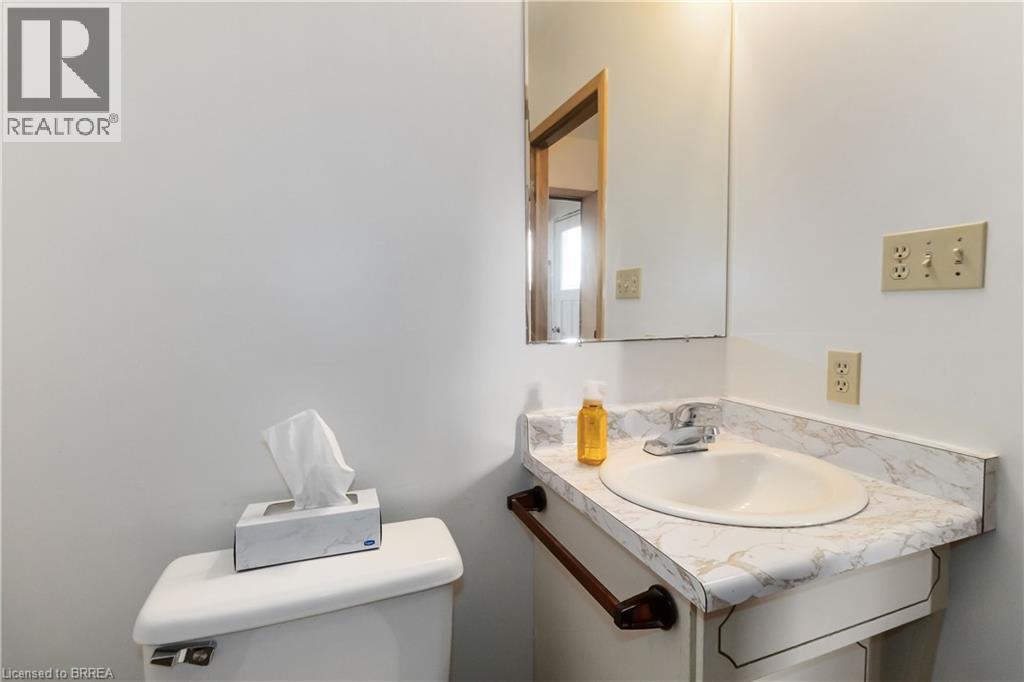 Half bathroom with vanity and toilet