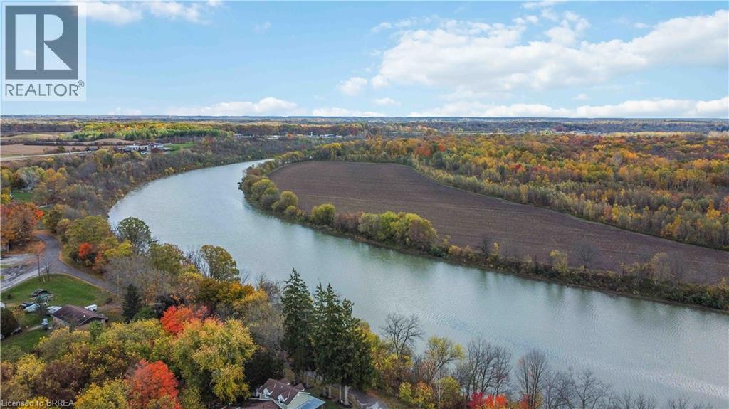 Bird's eye view of a heavily wooded area and a nearby body of water