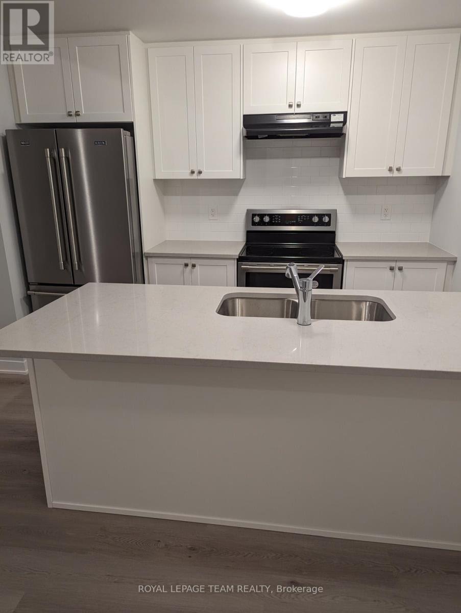 Kitchen w/granite counters & SS appliances.