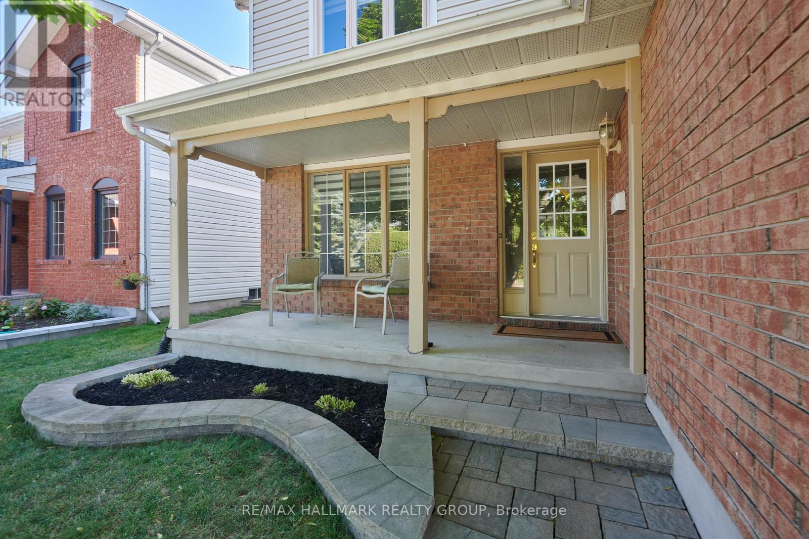 FRONT | covered porch, interlock pathway & garden