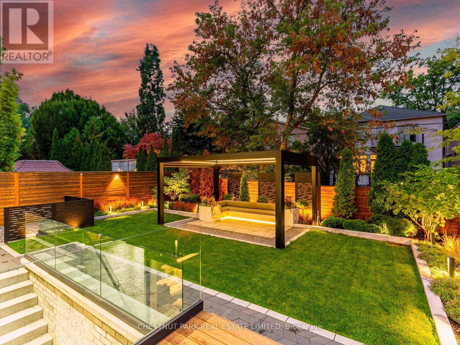 Beautifully landscaped yard with Custom Lighting