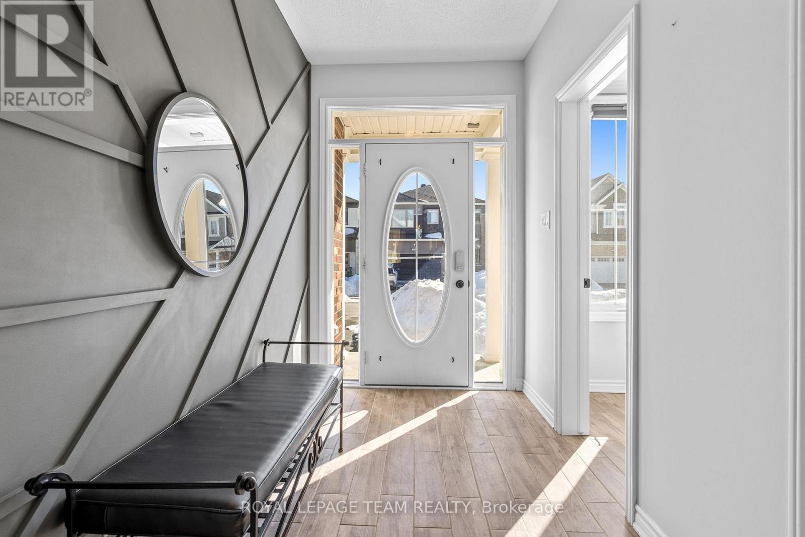 Sunlit foyer w/ custom wall detailing