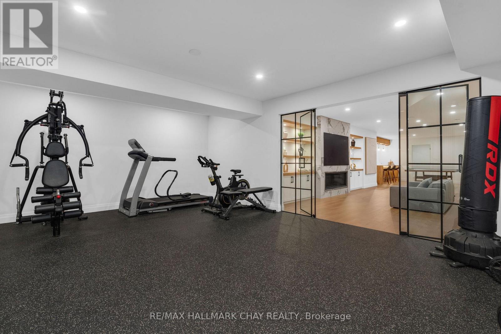 Home Gym with Glass Doors to Rec Room