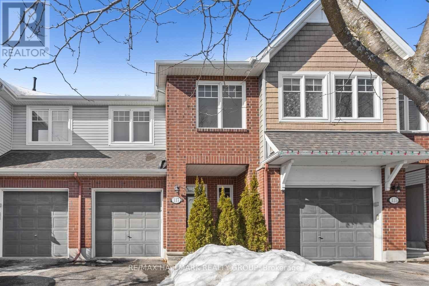 Front exterior of brick townhome with garage