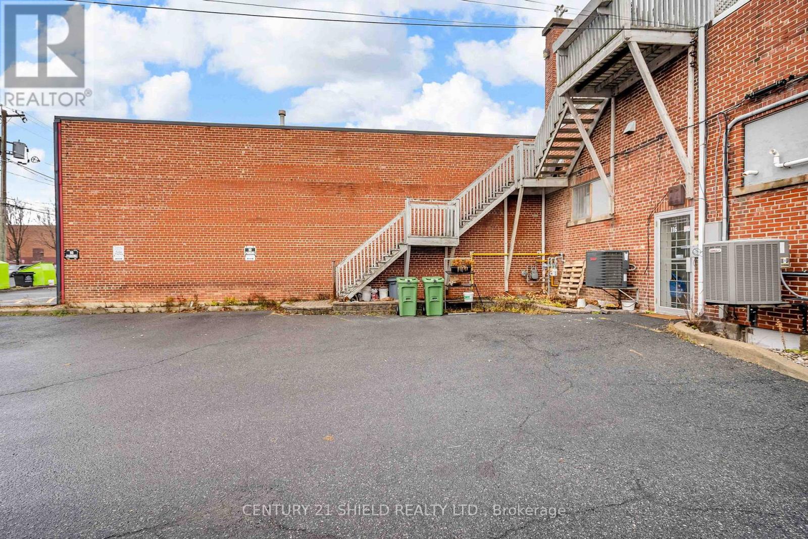 rear of building with 3 private parking spots