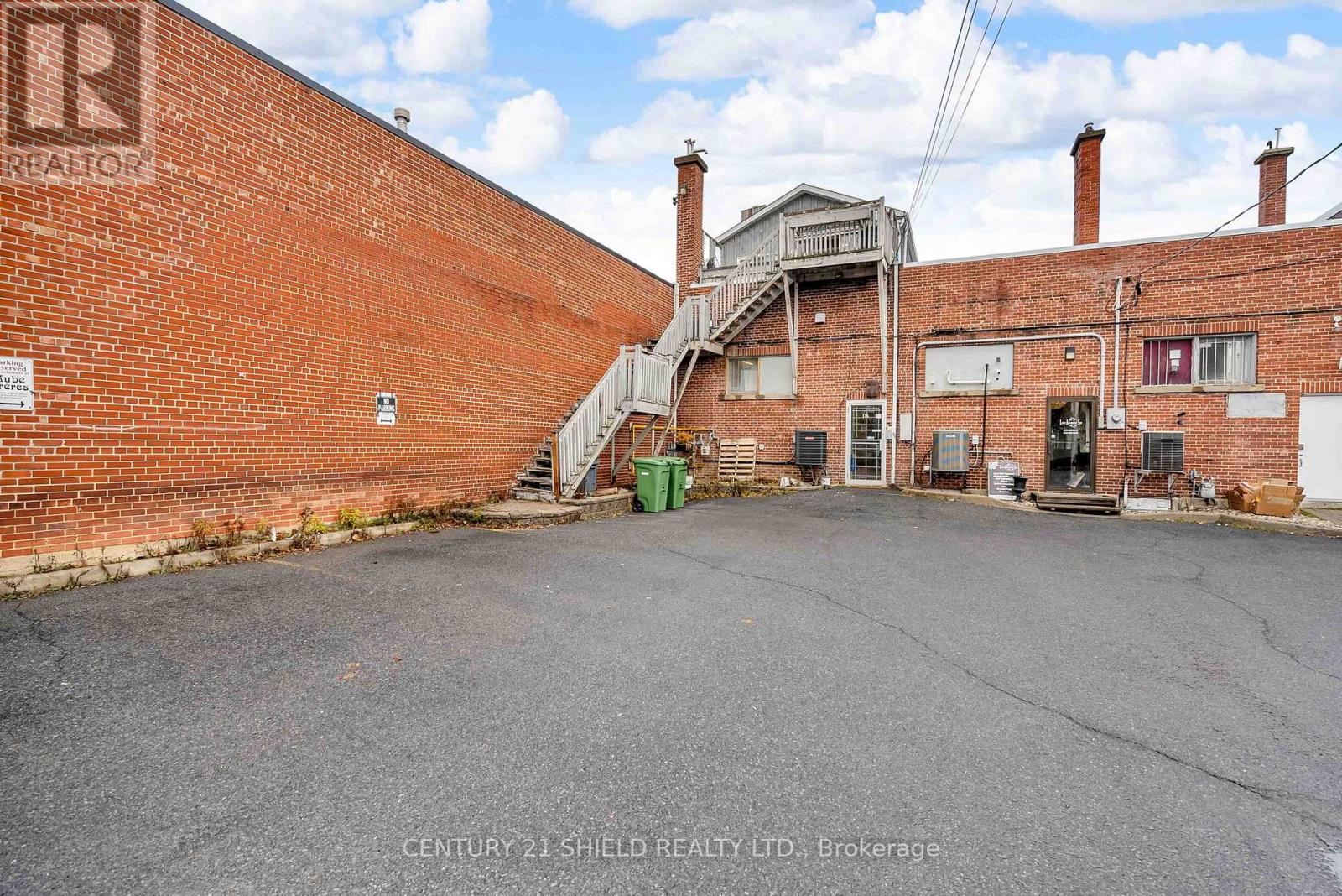 rear of building with 3 private parking spots