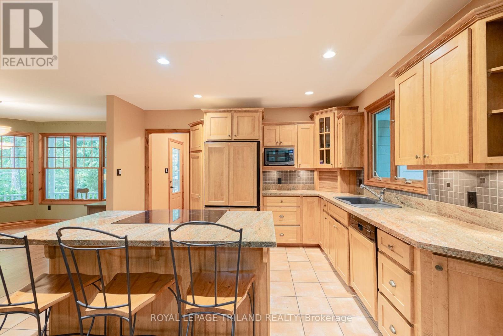 Beach colored kitchen w/ loads of cabinet space