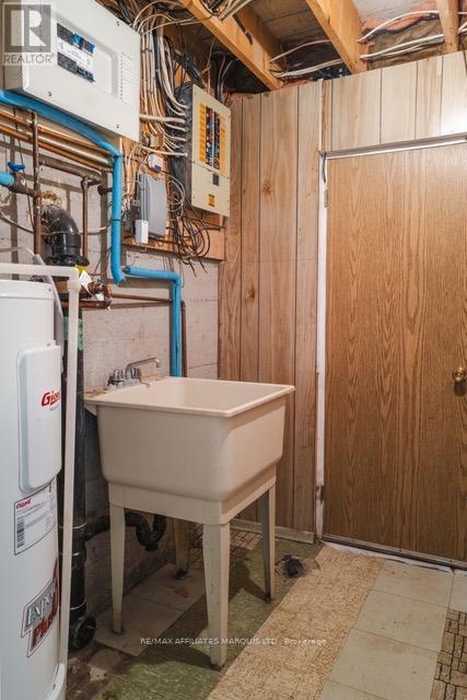 Basement utility room w door to cold room