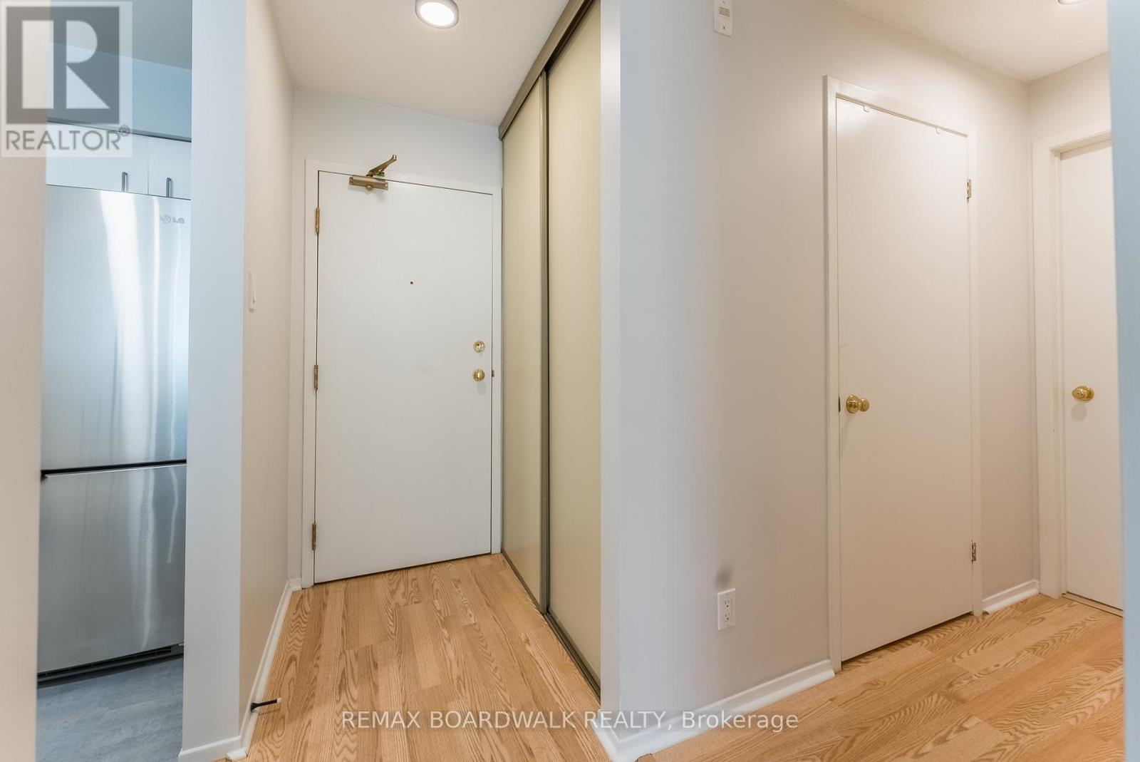 looking at front door w/closet & storage on right