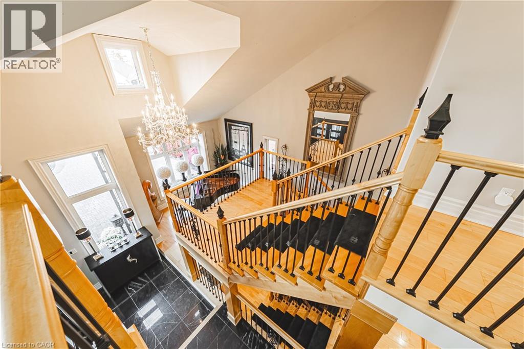 Staircase featuring a towering ceiling and a chandelier