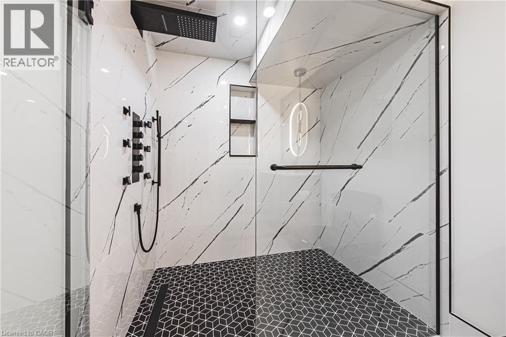 Full bath featuring a marble finish shower